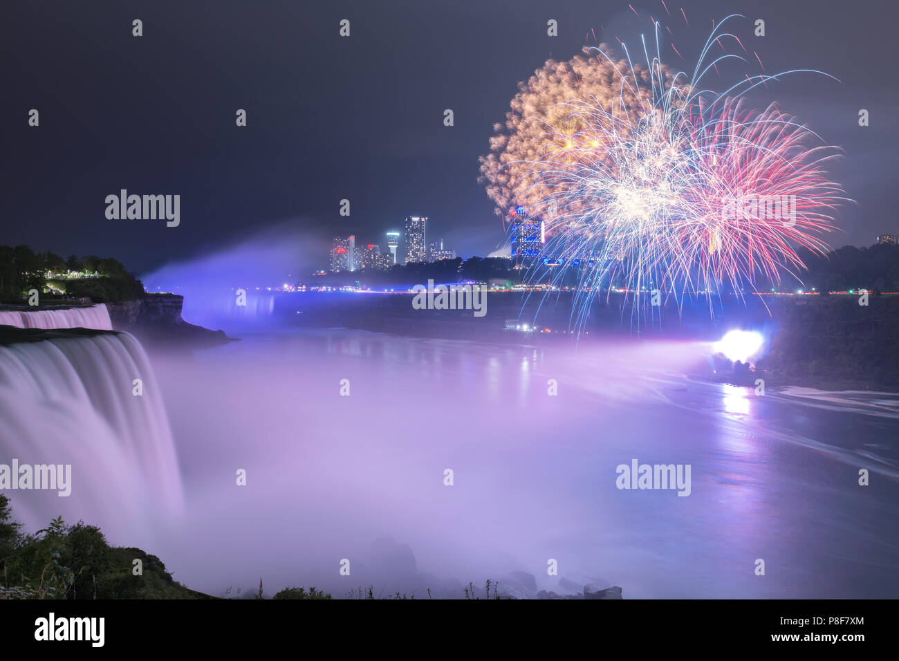 Niagara Falls lit at night by colorful fireworks Stock Photo