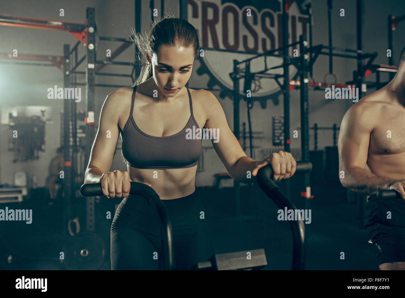Man and woman during exercises in the fitness gym Stock Photo - Alamy