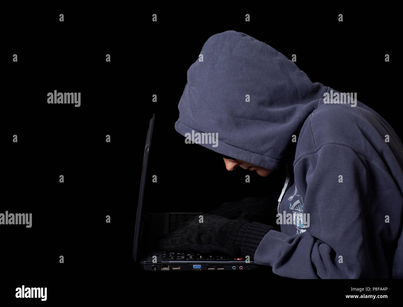 Hacker on a laptop.Concept of internet criminal hacking on black Stock Photo