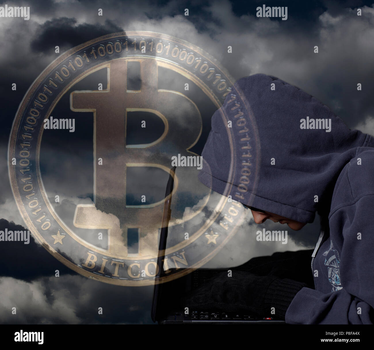 Crypto Hacker with laptop and bitcoin on dramatic sky .Concept of internet  criminal hacking Stock Photo - Alamy