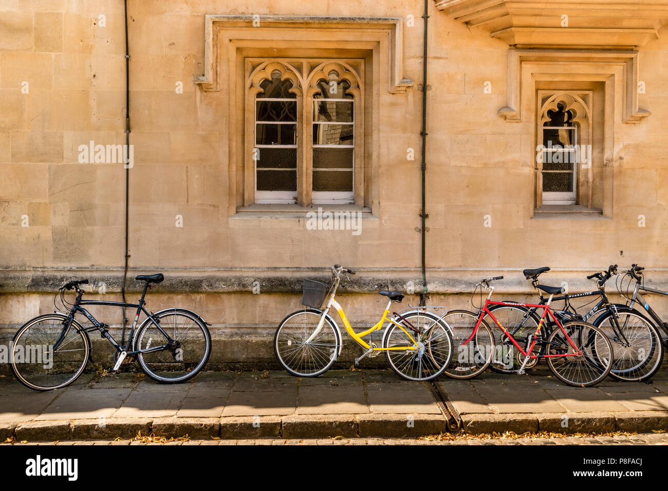 bicycles against a wall in Oxford city centre. Stock Photo