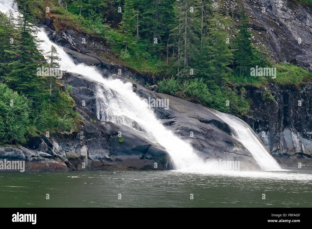 Large double waterfall coming from the mountain range in Alaska Stock ...