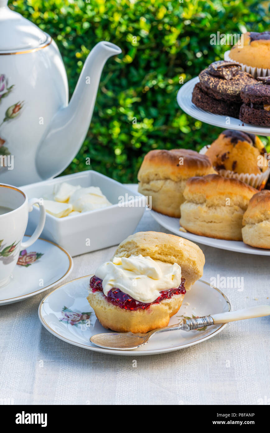 Afternoon tea with cakes and traditional English scones with strawberry