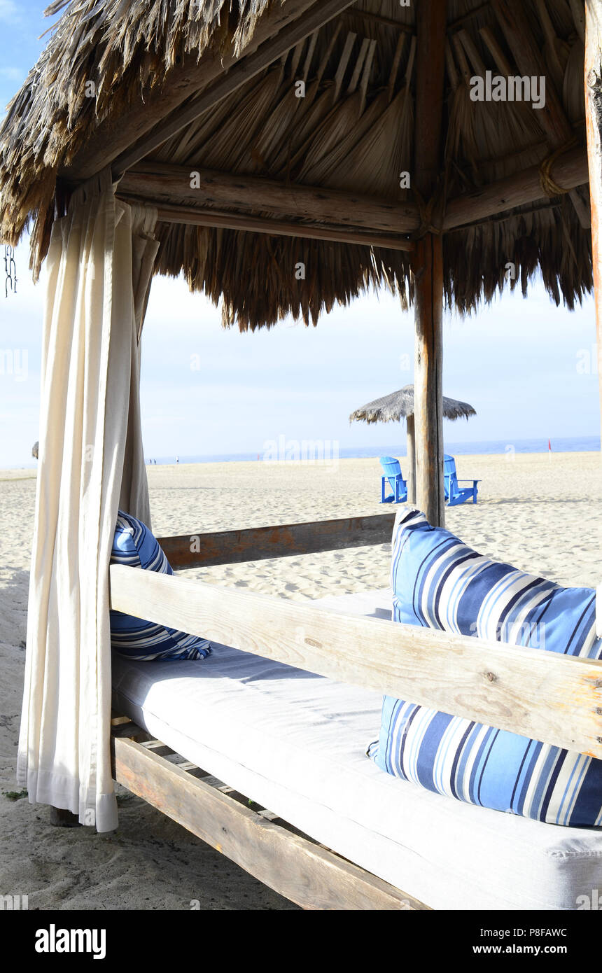 tropical outdoor beach bed luxury relaxation glamping palm thatched