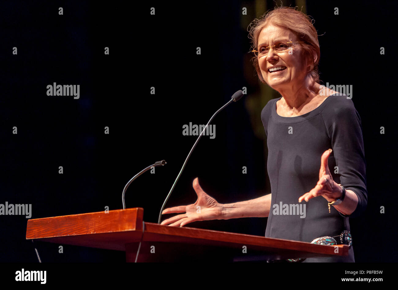 Gloria Steinem stands at a podium giving a lecture. Stock Photo