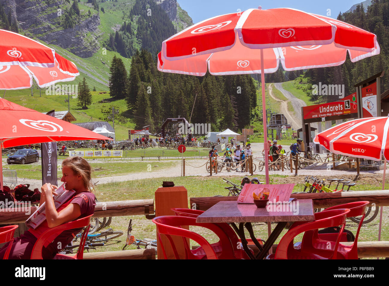 The Beautiful Chalet Style Les Barmettes Restaurant and Bar with Red Umbrellas at Les Lindarets near Montriond Haute-Savoie France Stock Photo