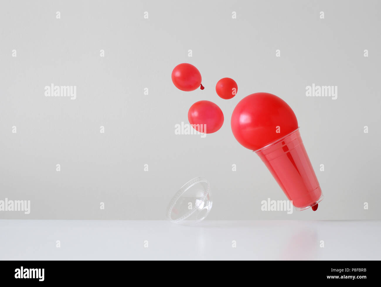 Conceptual slush drink spilling out of a plastic disposable cup Stock Photo