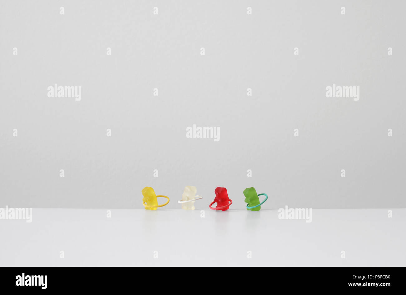 Gummy bears exercising with plastic hoops Stock Photo