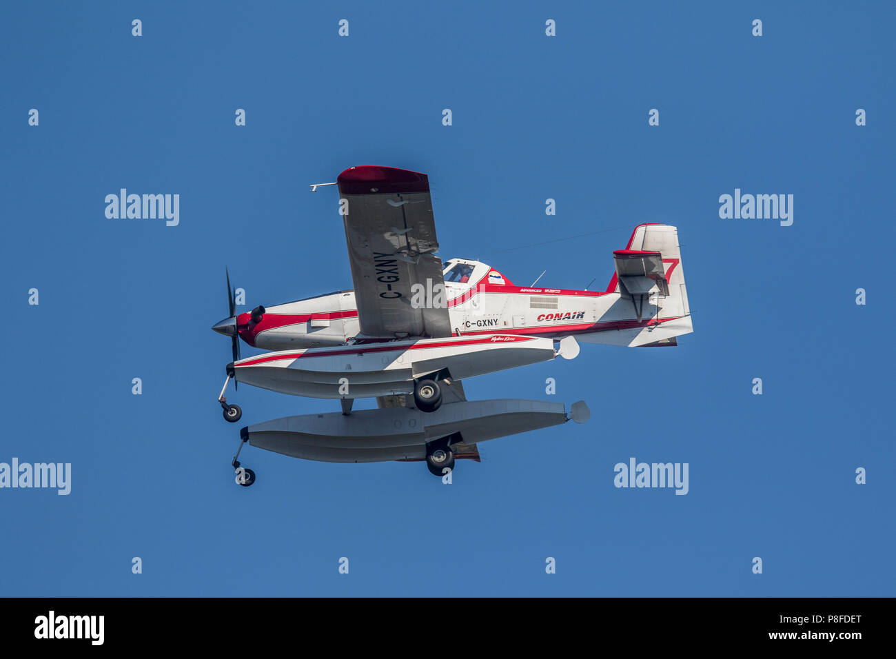 Small Air Tractor water bomber aircraft, with twin pontoons, fighting