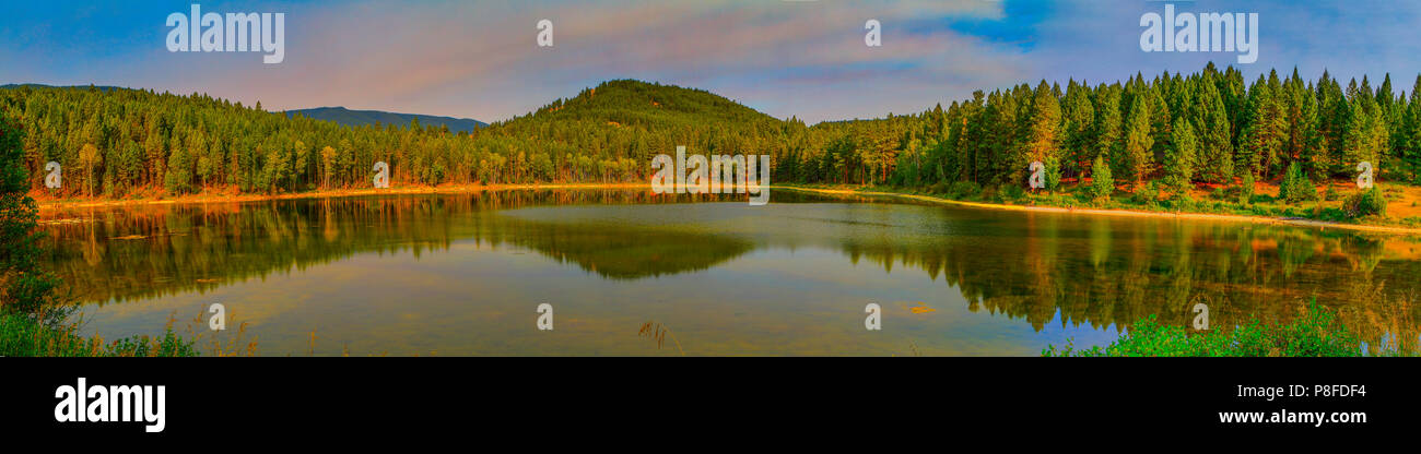 Panorama of Ho Ho Creek Pond. Scenic, pictureesqe, calm, sunrise photo. Cranbrook, British Columbia, Canada Stock Photo