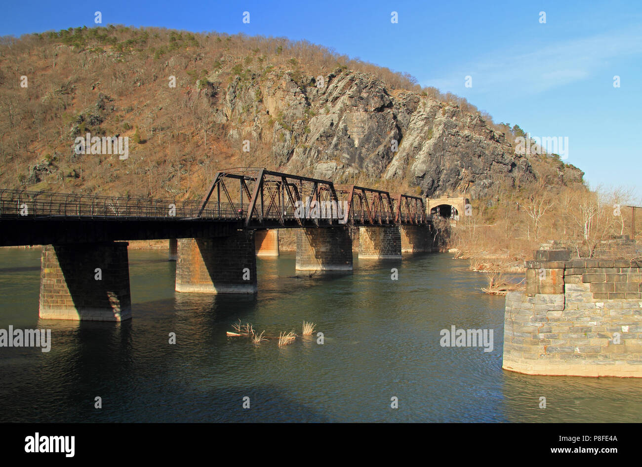 A truss bridge crosses the Potomac River and connects the historic town of Harpers Ferry, West Virginia, to Maryland Heights in the state of Maryland Stock Photo