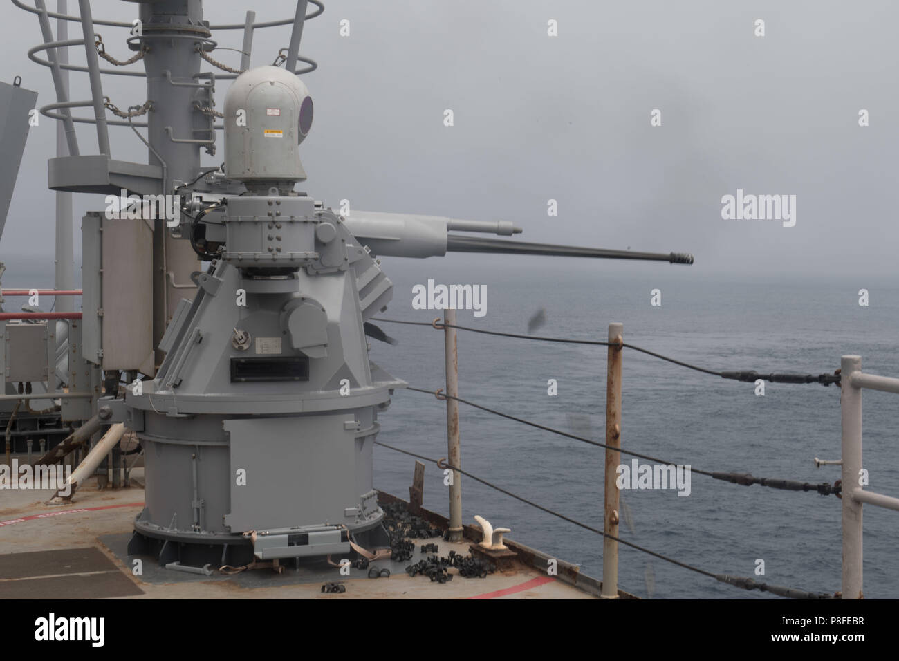 180710-N-OW019-1364 PACIFIC OCEAN (July 10, 2018) A MK38 25MM gun is fired  on the port wing wall of the amphibious dock landing ship USS Harpers Ferry  (LSD 49) during a gun exercise