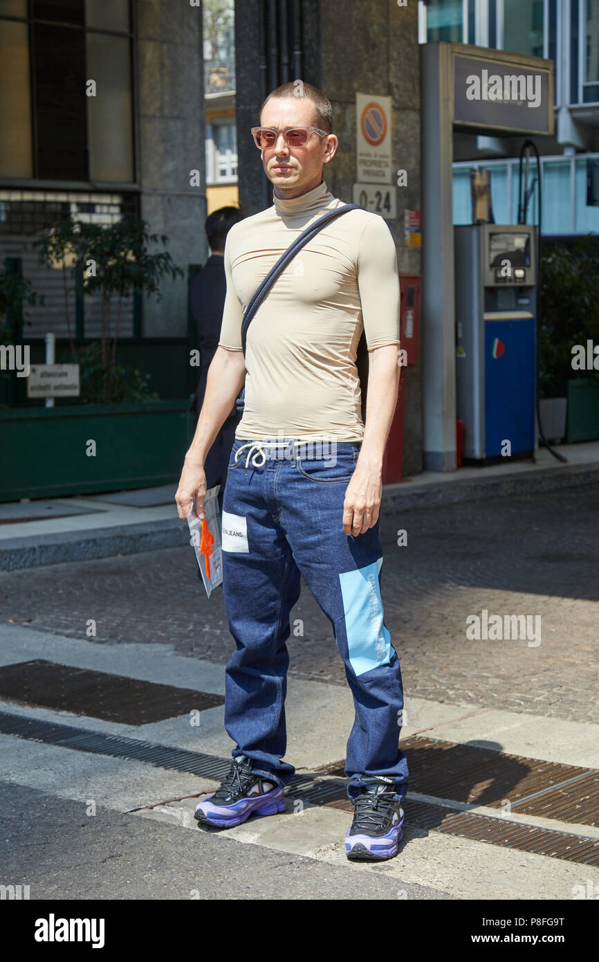 MILAN - JUNE 16: Man with Calvin Klein jeans, beige turtle neck shirt  before Marni fashion show, Milan Fashion Week street style on June 16, 2018  in M Stock Photo - Alamy