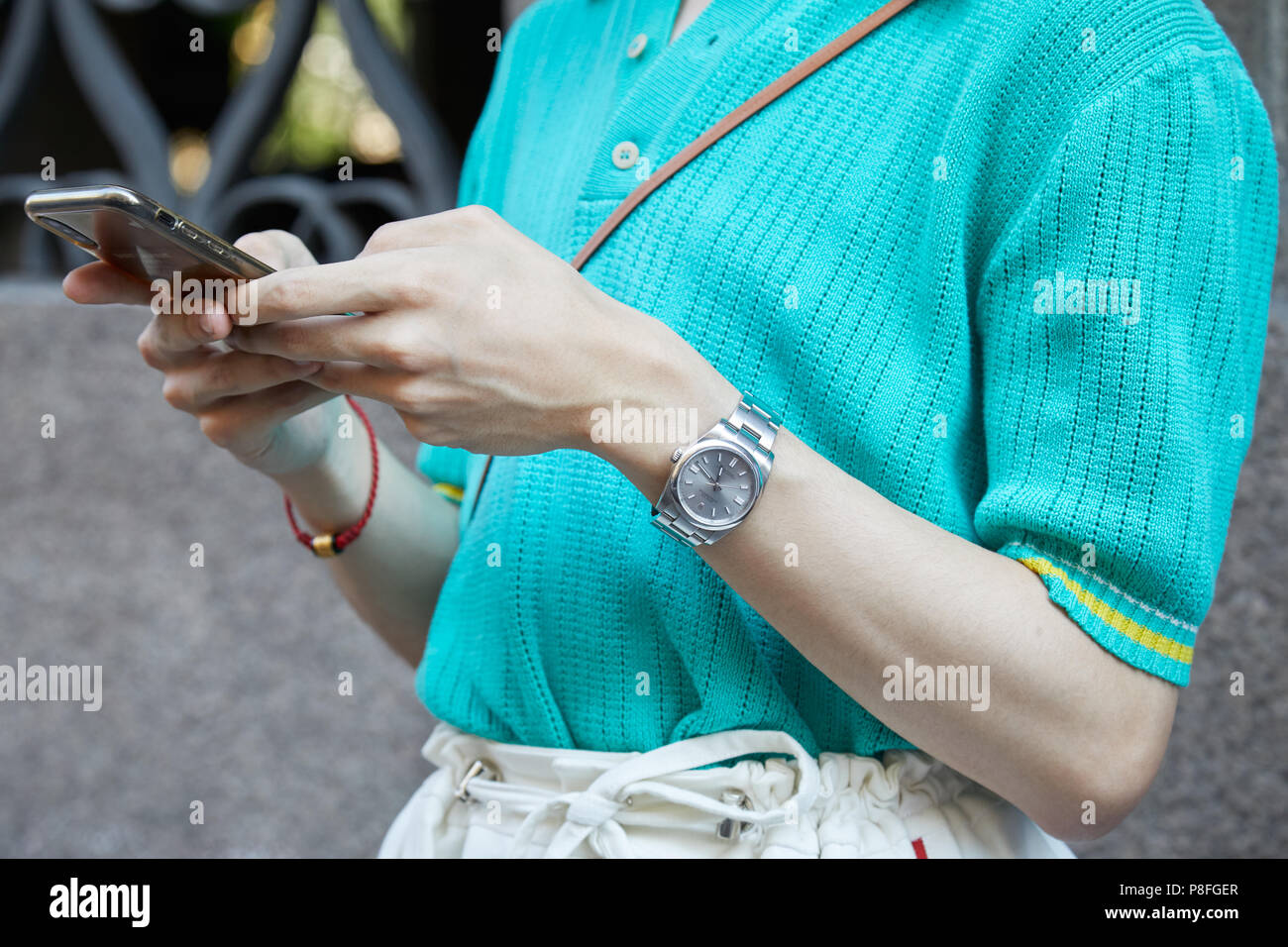 MILAN - JUNE 16: Man with Rolex watch with gray dial looking at smartphone  before Versace fashion show, Milan Fashion Week street style on June 16, 20  Stock Photo - Alamy