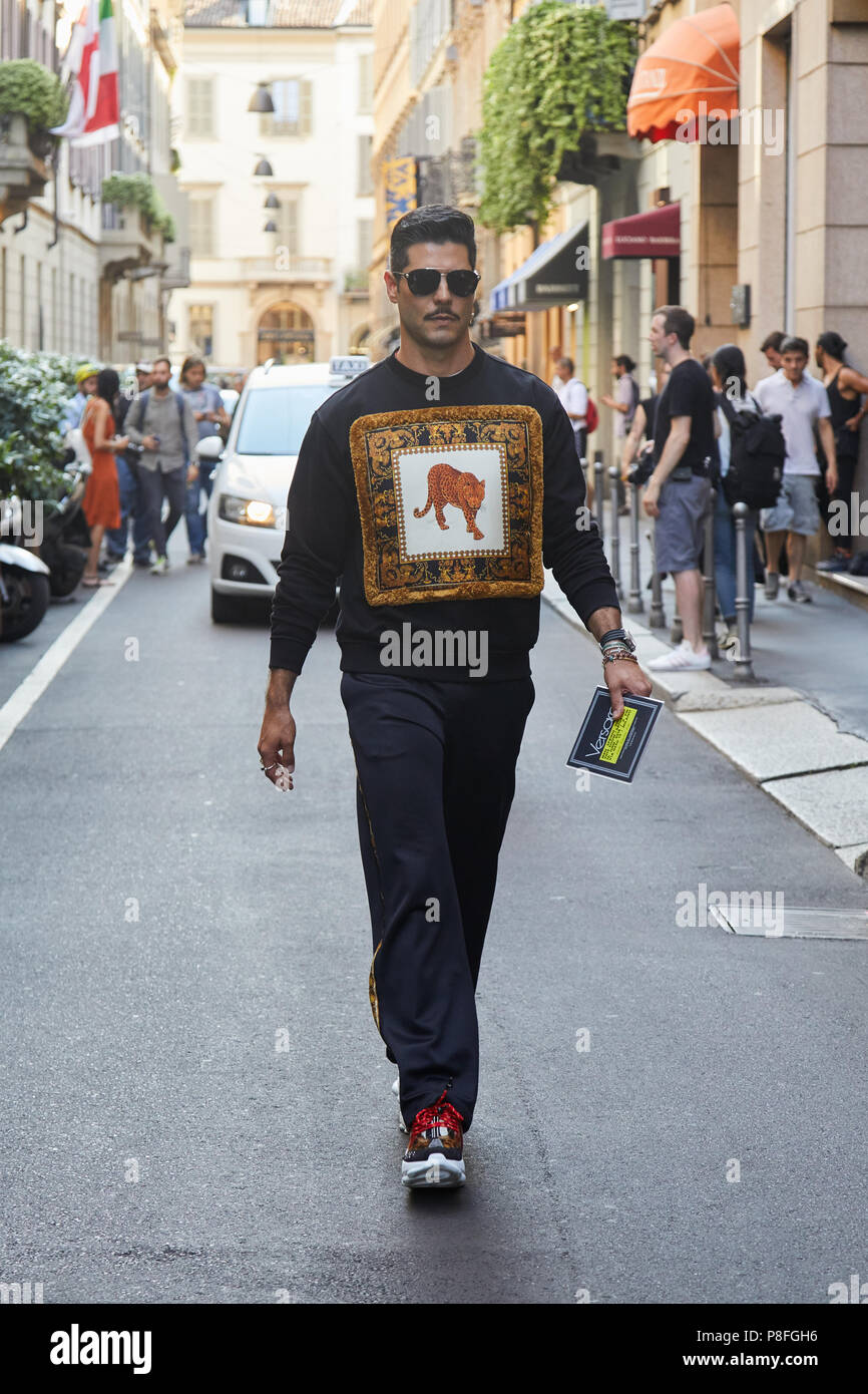 MILAN - JUNE 16: Man with Versace sweater with leopard design and golden  decoration before Versace fashion show, Milan Fashion Week street style on  Ju Stock Photo - Alamy