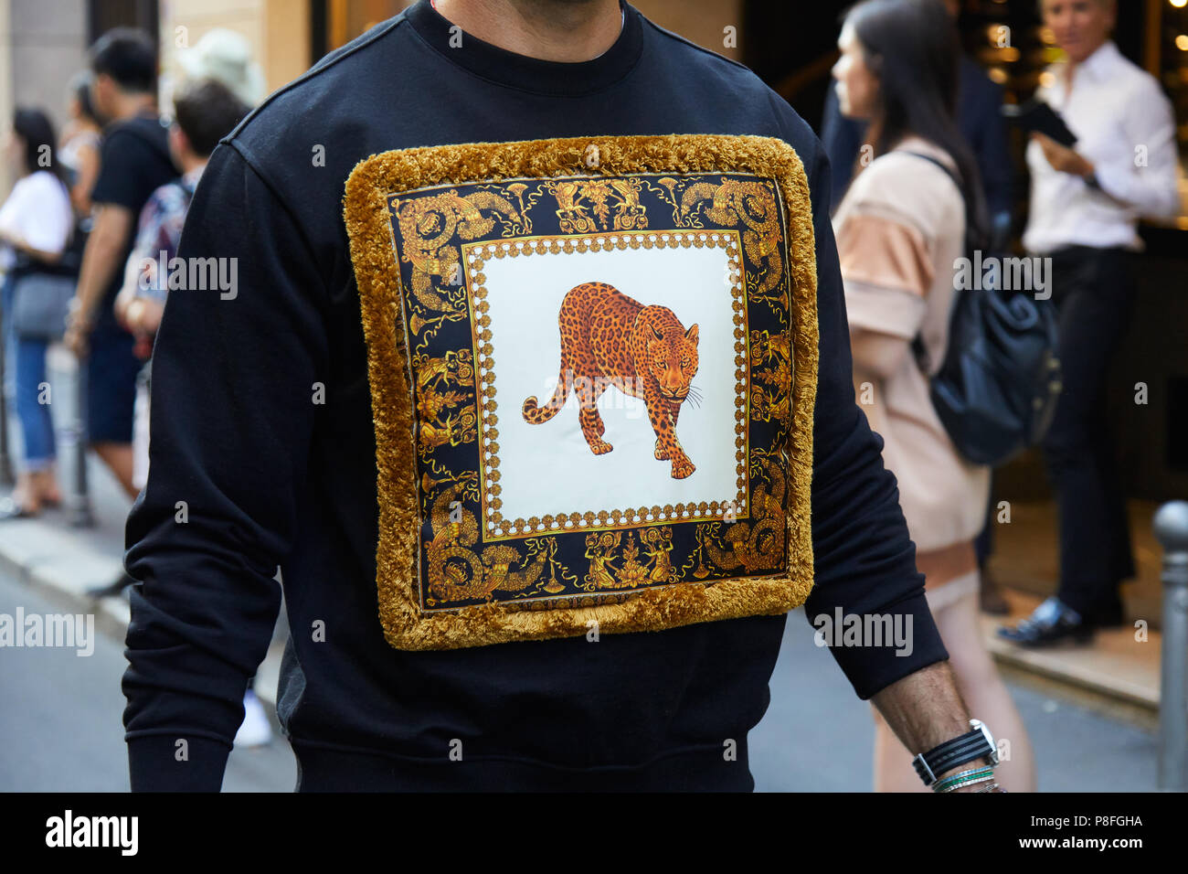 MILAN - JUNE 16: Man with Versace sweatshirt with leopard design and golden  decorations before Versace fashion show, Milan Fashion Week street style o  Stock Photo - Alamy
