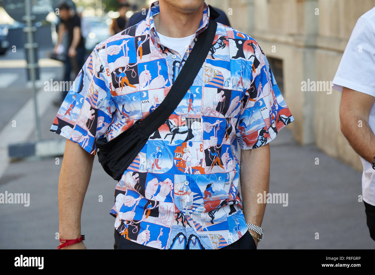 MILAN - JUNE 17: Man with comics in blue and red colors on tshirt before  Prada fashion show, Milan Fashion Week street style on June 17, 2018 in  Milan Stock Photo - Alamy