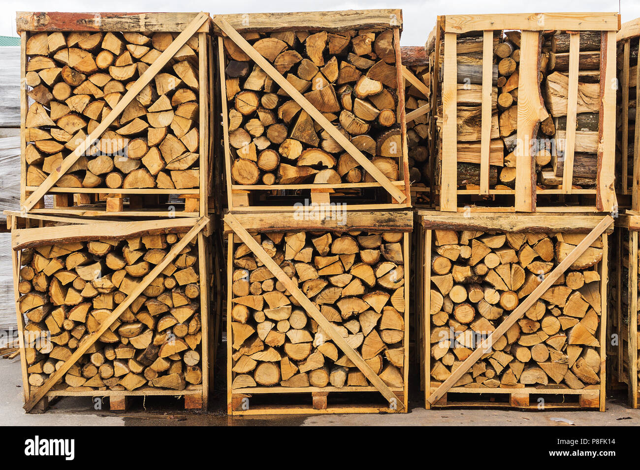Folded and packaged firewood on pallets Stock Photo - Alamy
