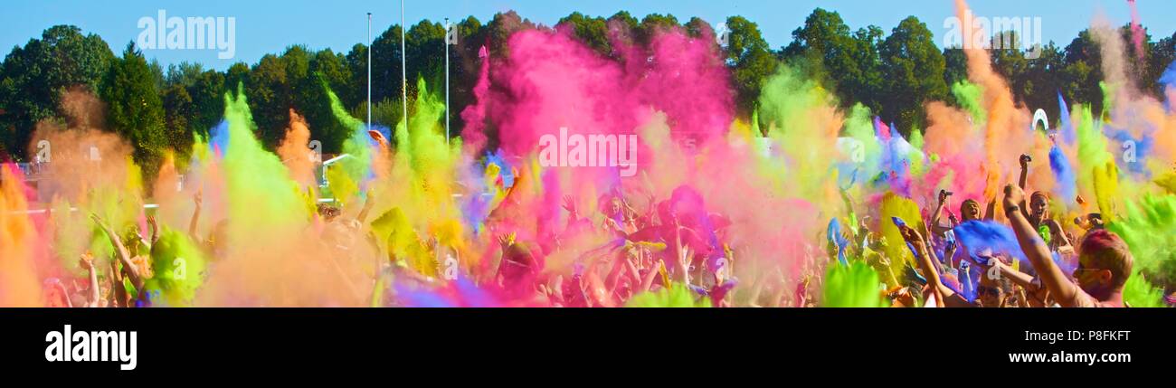 People throwing packs with coloured dust at Holi festival of colours ...