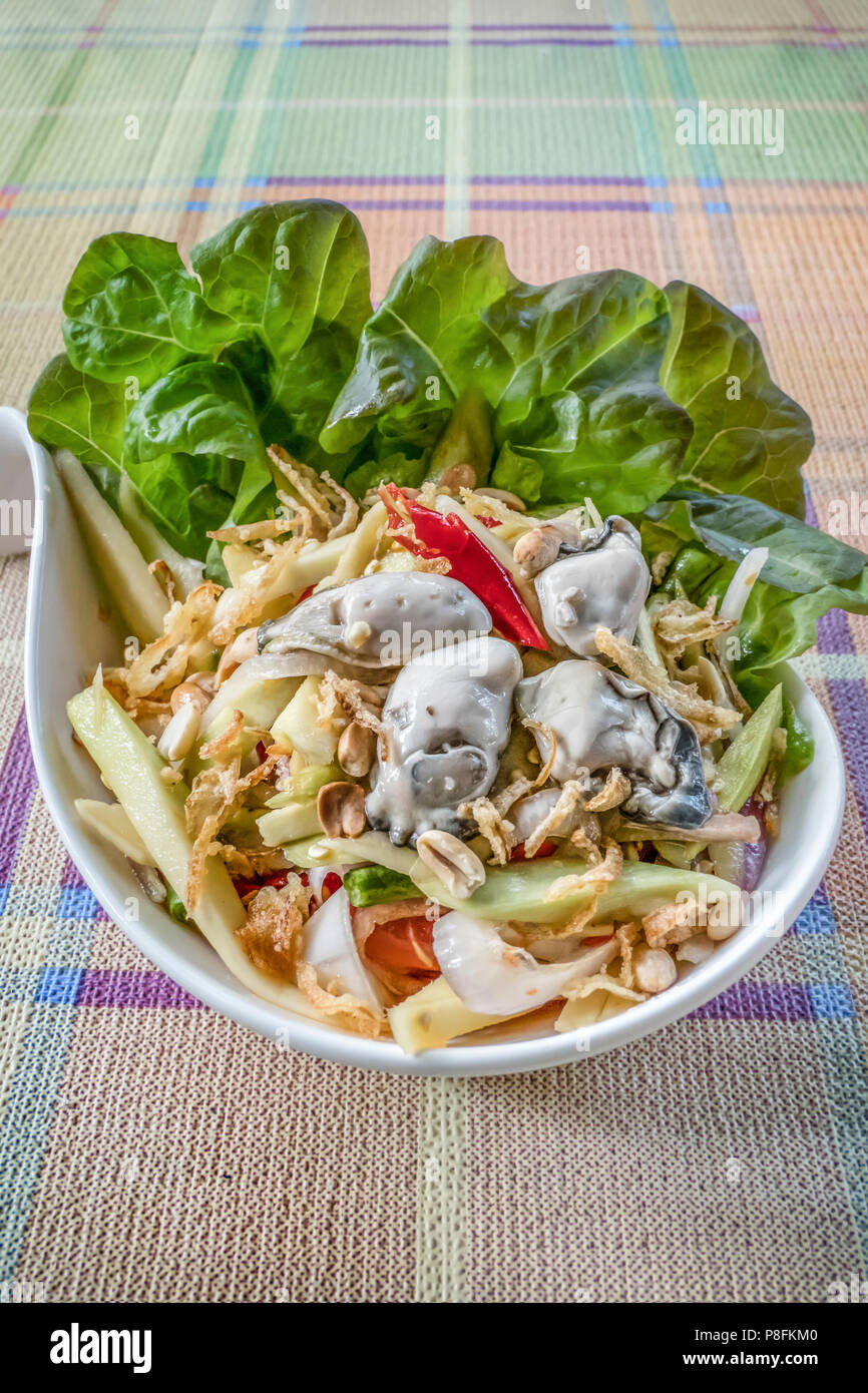 spicy yellow mango salad with fresh oyster , shallot garnish and crispy shallot Stock Photo Alamy