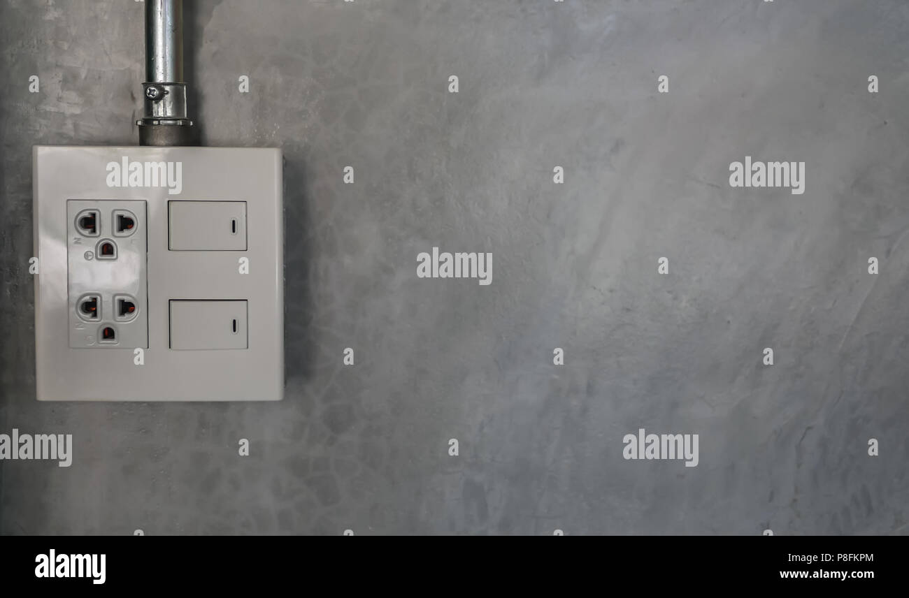 electric plug and switch on gray wall Stock Photo Alamy