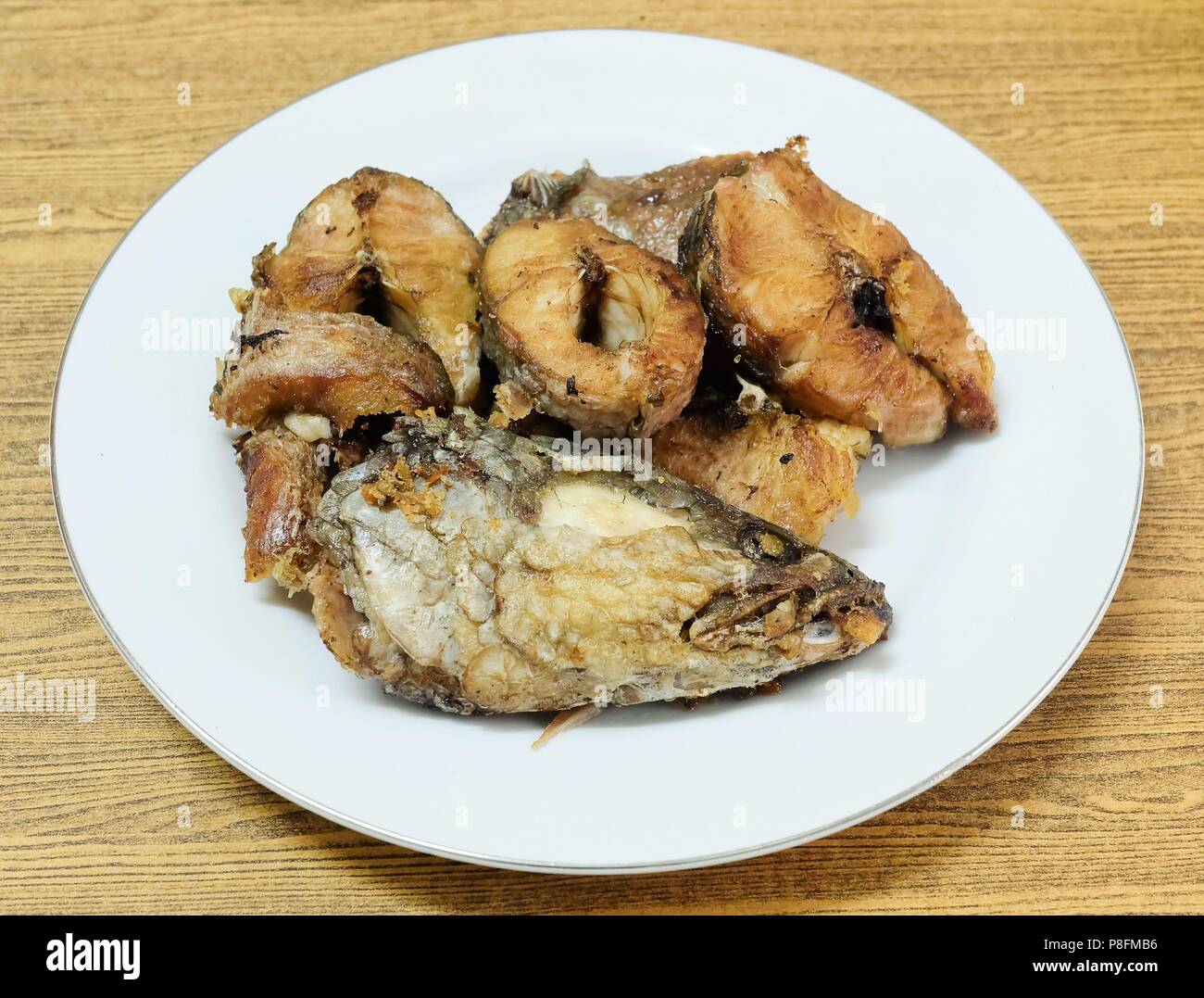 Traditional Delicuous Deep Fried Striped Snakehead Fish on A White Plate,  High in Protein, Vitamin B12, Niacin or B3 and Omega-3, Essential Nutrient  f Stock Photo - Alamy