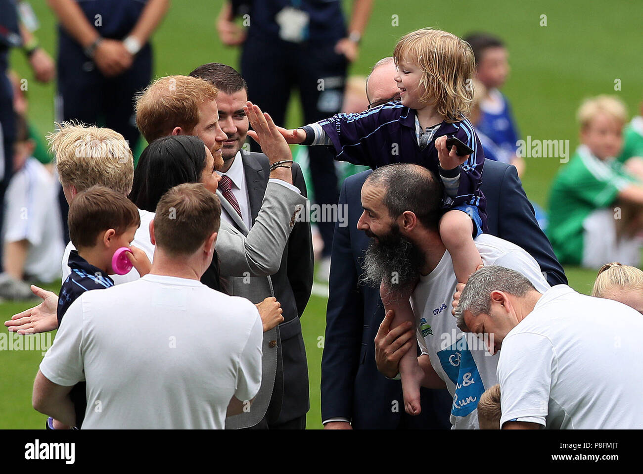The Duke of Sussex gives a high five to Walter Kieran, 3, prior to him touching the Duchess of Sussex's hair during during a visit to Croke Park on the second day of their visit to Dublin, Ireland. Picture date: Wednesday July 11, 2018. See PA story ROYAL Sussex. Photo credit should read: Brian Lawless/PA Wire Stock Photo