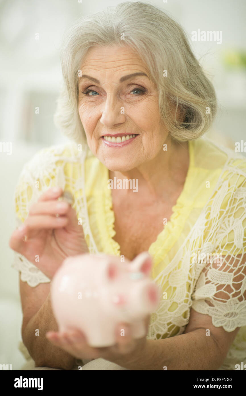 old woman with piggy bank Stock Photo - Alamy