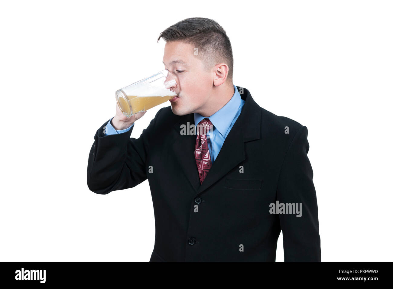 Businessman drinking beer from mug Stock Photo