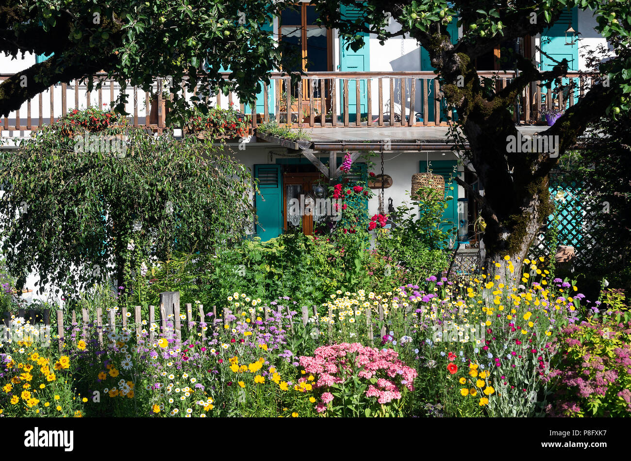 A Beautiful Colourful Summer Flower Garden Outside a Cottage with a Balcony near Morzine Haute-Savoie Portes du Soleil French Alps France Stock Photo