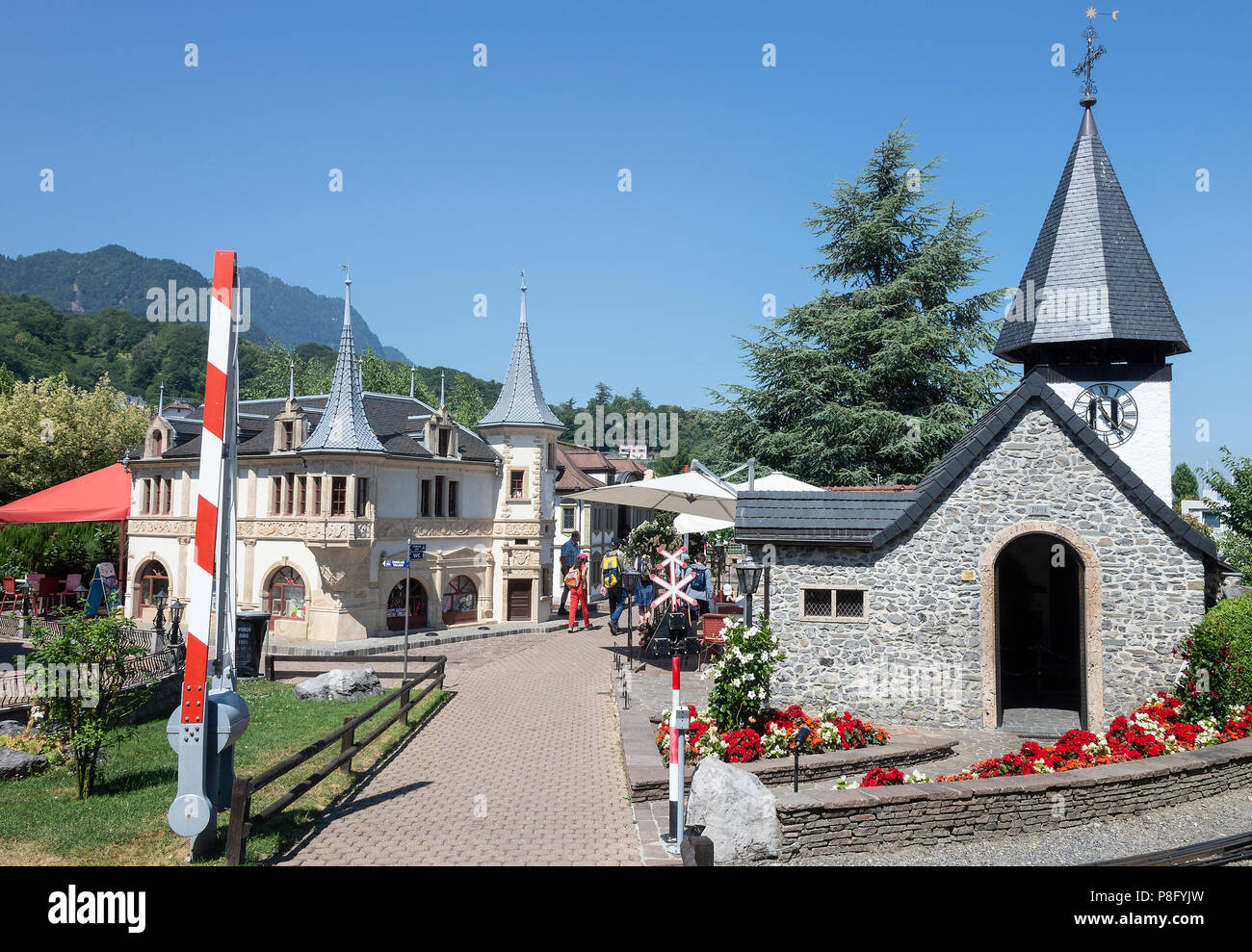 The Spired Miniature Church and the Turreted Halles de Neuchatel Souvenir Shop at the Swiss Vapeur Parc by Lake Geneva Le Bouveret Switzerland Stock Photo