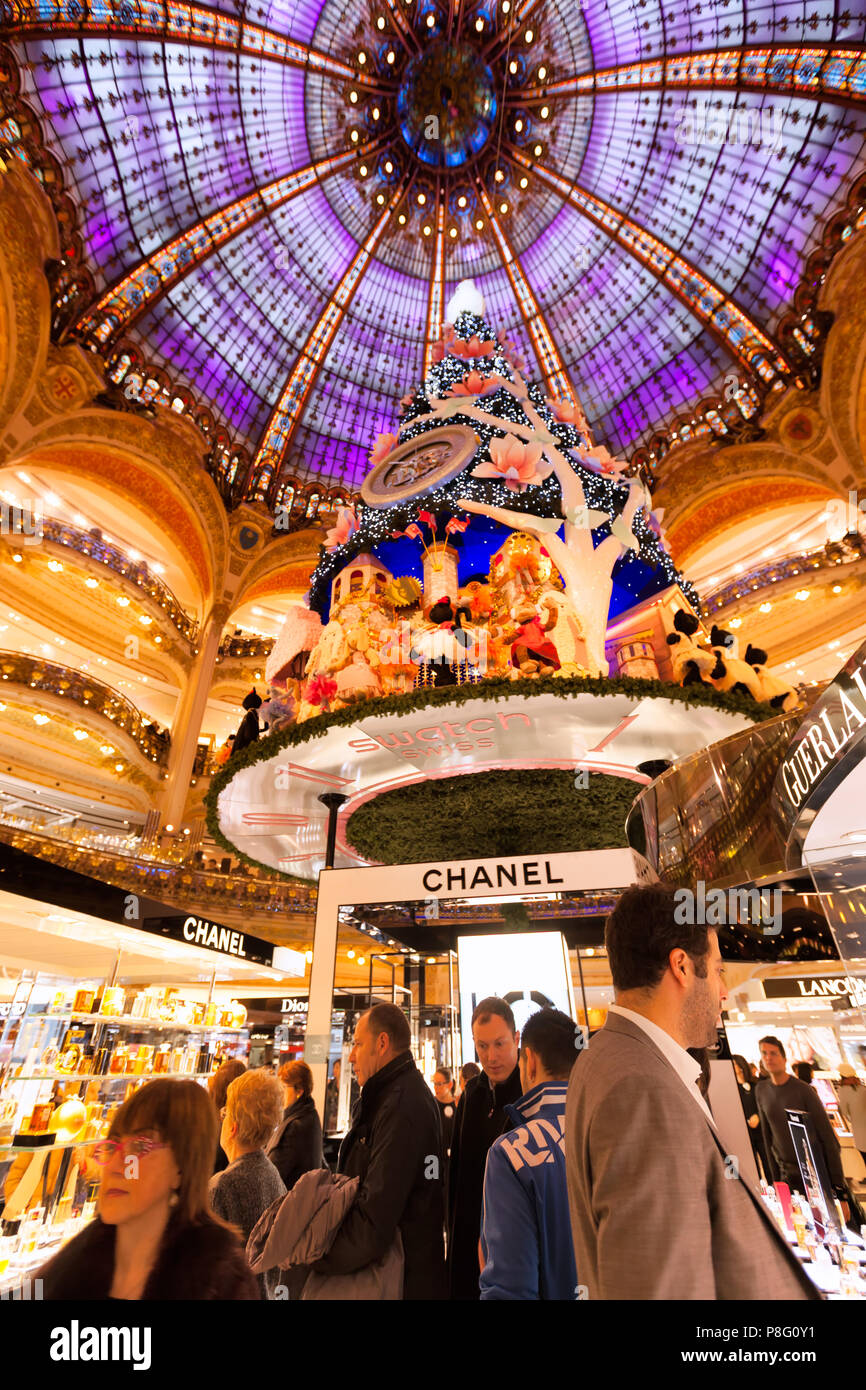 PARIS-DEC 24, 2013: Christmas shoppers crowd the aisles at the Galleries Lafayette, the city's famous department store. Stock Photo
