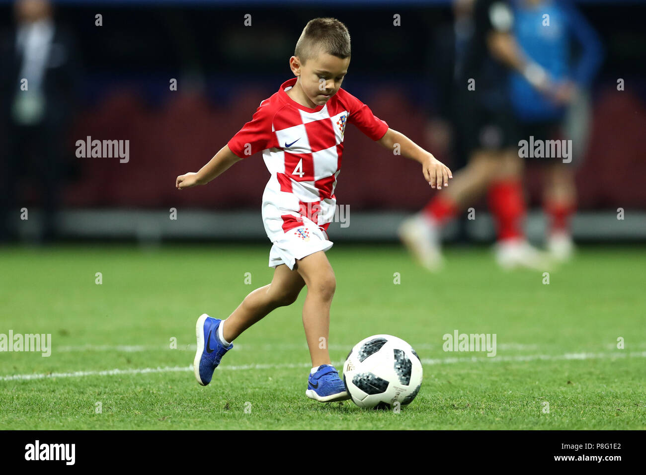 A young croatia fan wearing the shirt of Croatia's Ivan Perisic on the pitch after the final whistle of the FIFA World Cup, Semi Final match at the Luzhniki Stadium, Moscow. PRESS ASSOCIATION Photo. Picture date: Wednesday July 11, 2018. See PA story WORLDCUP Croatia. Photo credit should read: Tim Goode/PA Wire. Stock Photo