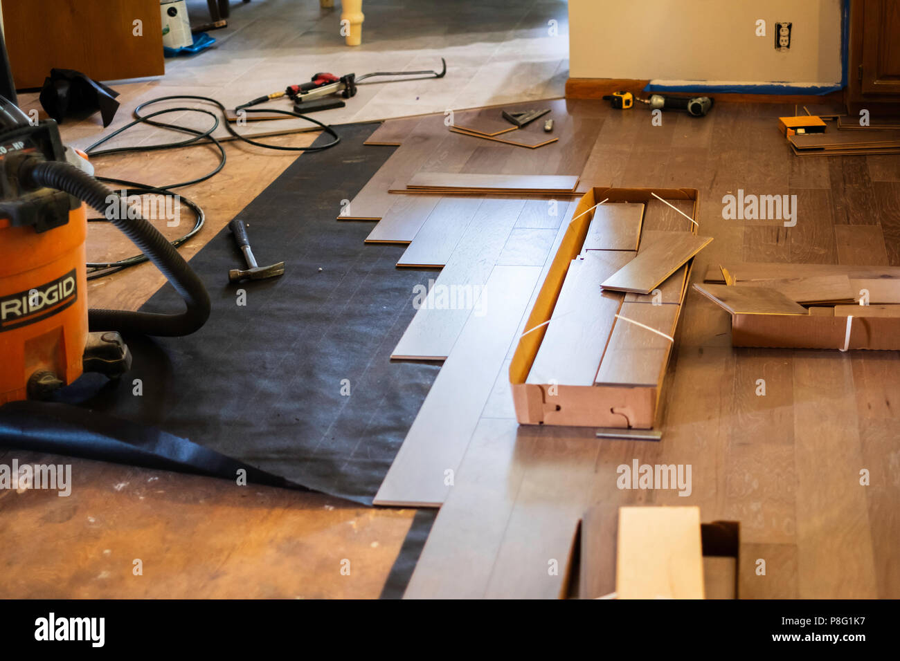 Interior of a home where engineered wood floor is being laid. USA. Stock Photo
