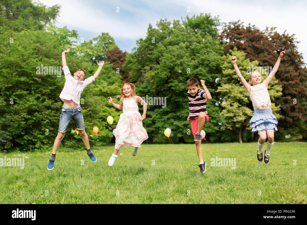 Happy Kids Jumping In Summer Park Stock Photo Alamy