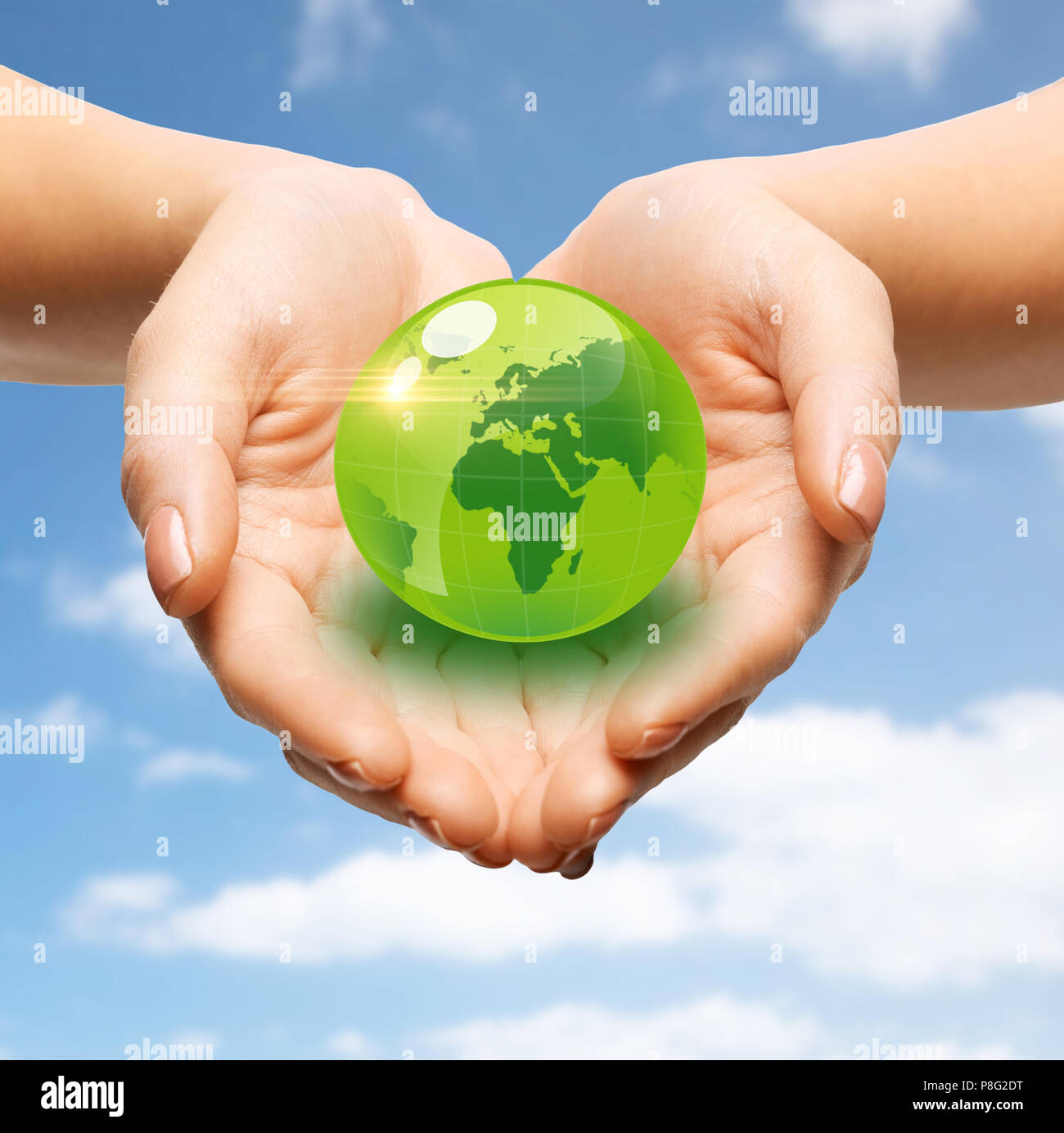close up of female hands holding green globe Stock Photo