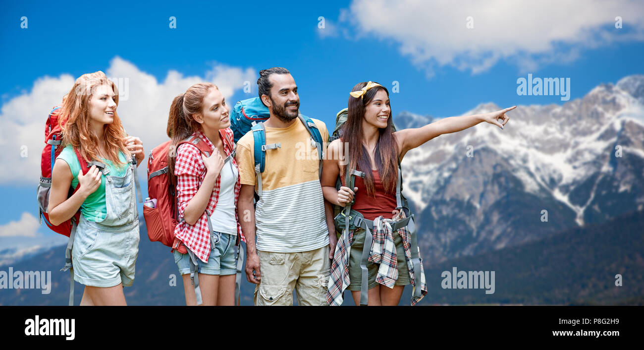 group of friends with backpacks over mountains Stock Photo - Alamy