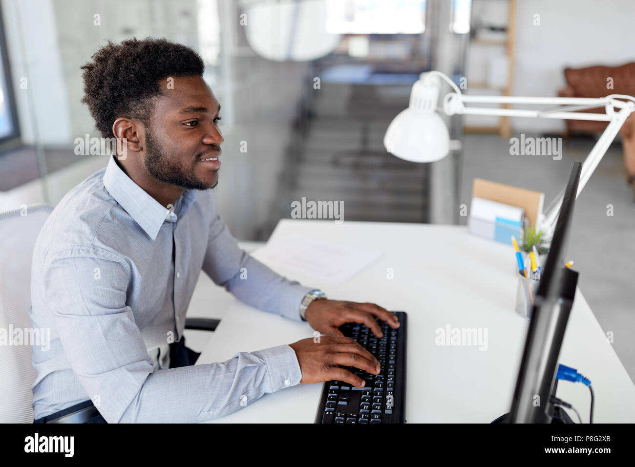 Black man works computer typing hi-res stock photography and images - Alamy