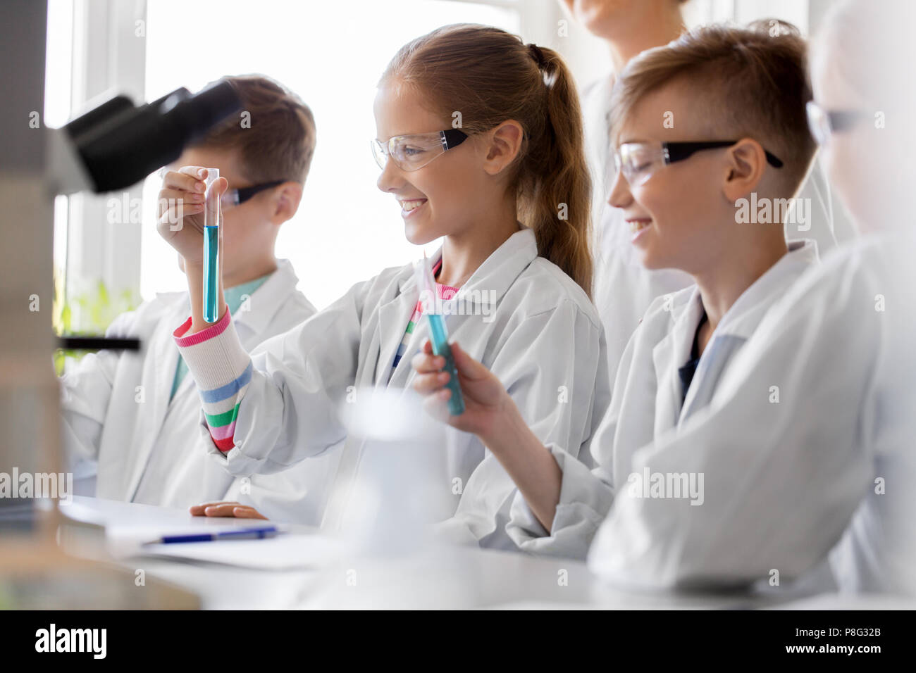 teacher and students studying chemistry at school Stock Photo - Alamy