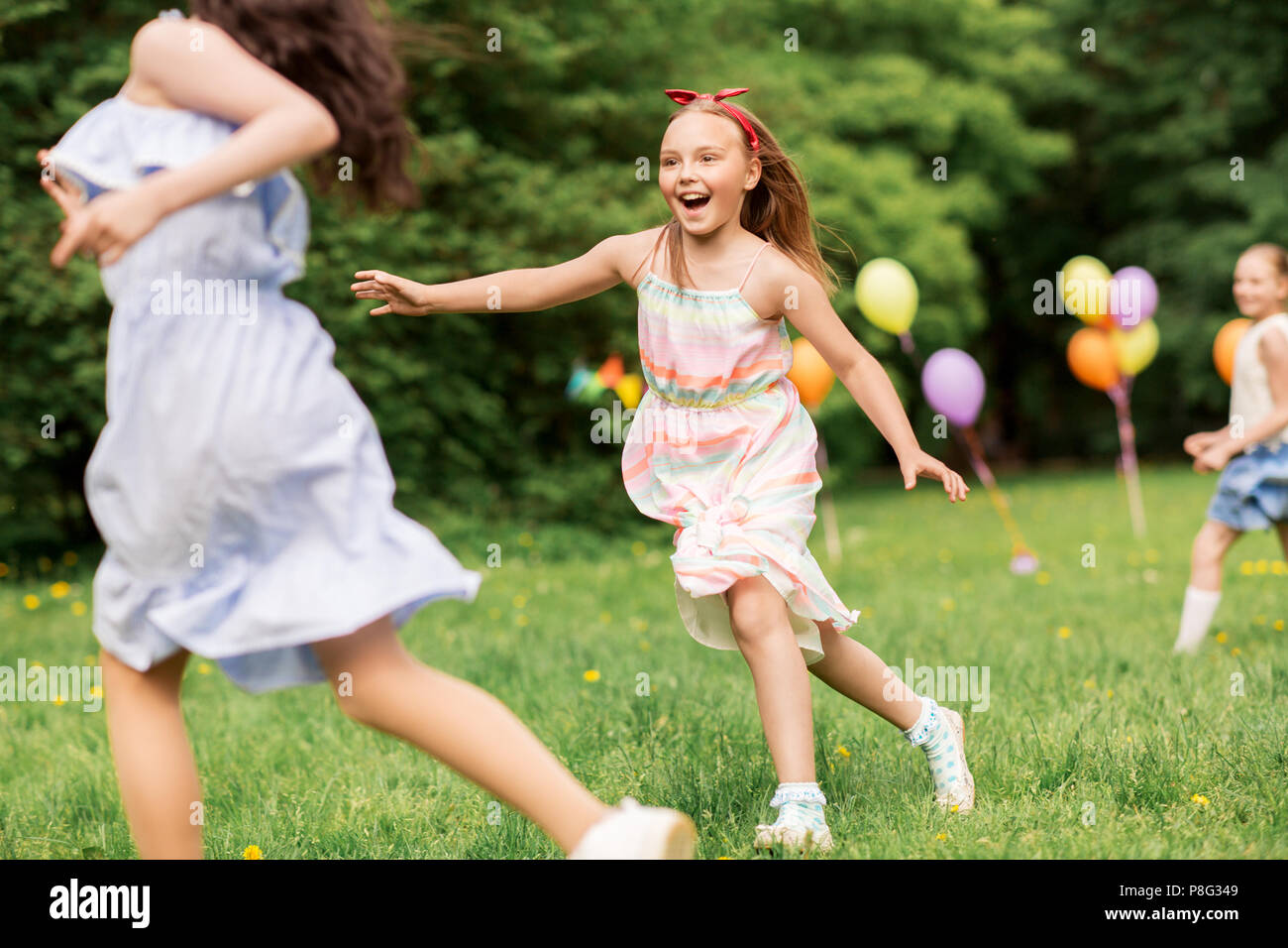 happy girls playing tag game at birthday party Stock Photo Alamy