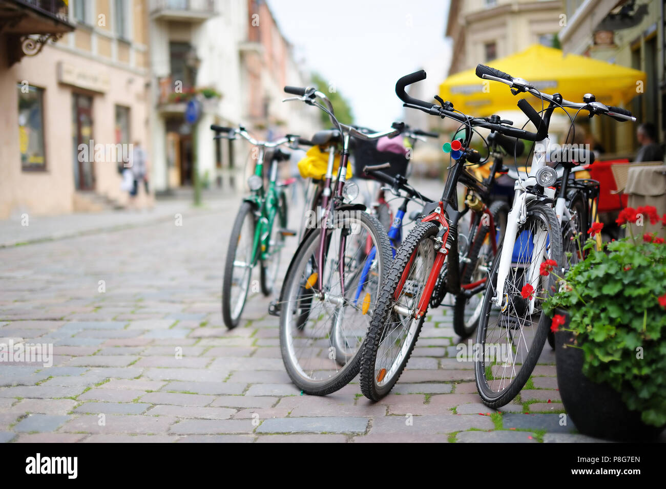 Row of parked colorful bikes on a street Stock Photo