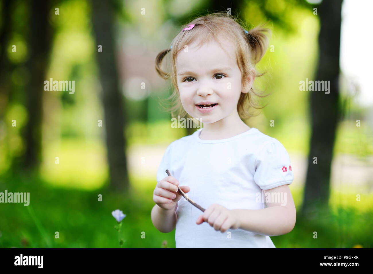 Adorable little girl portrait outdoors at summer Stock Photo - Alamy