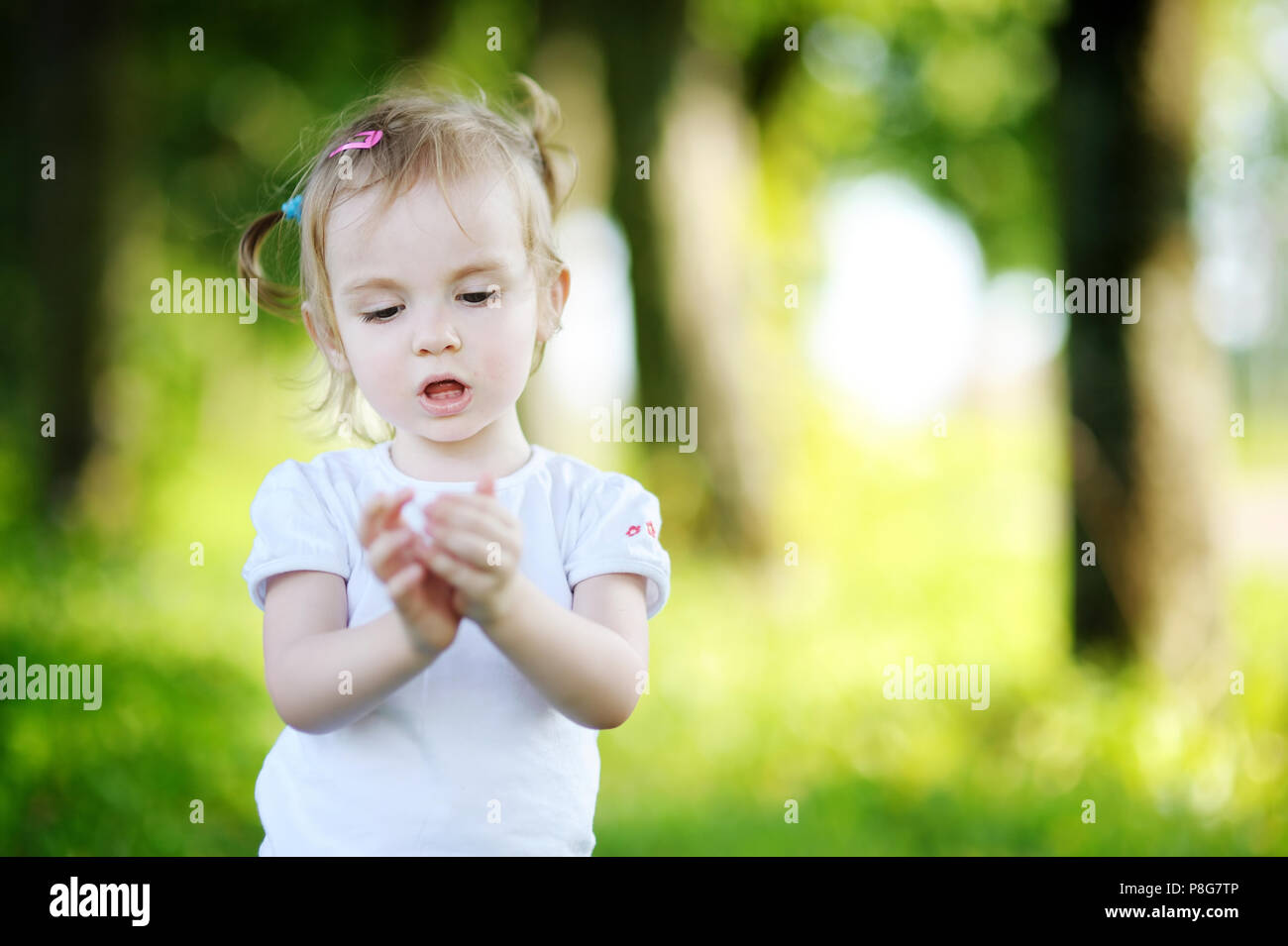 Adorable little girl portrait outdoors at summer Stock Photo - Alamy