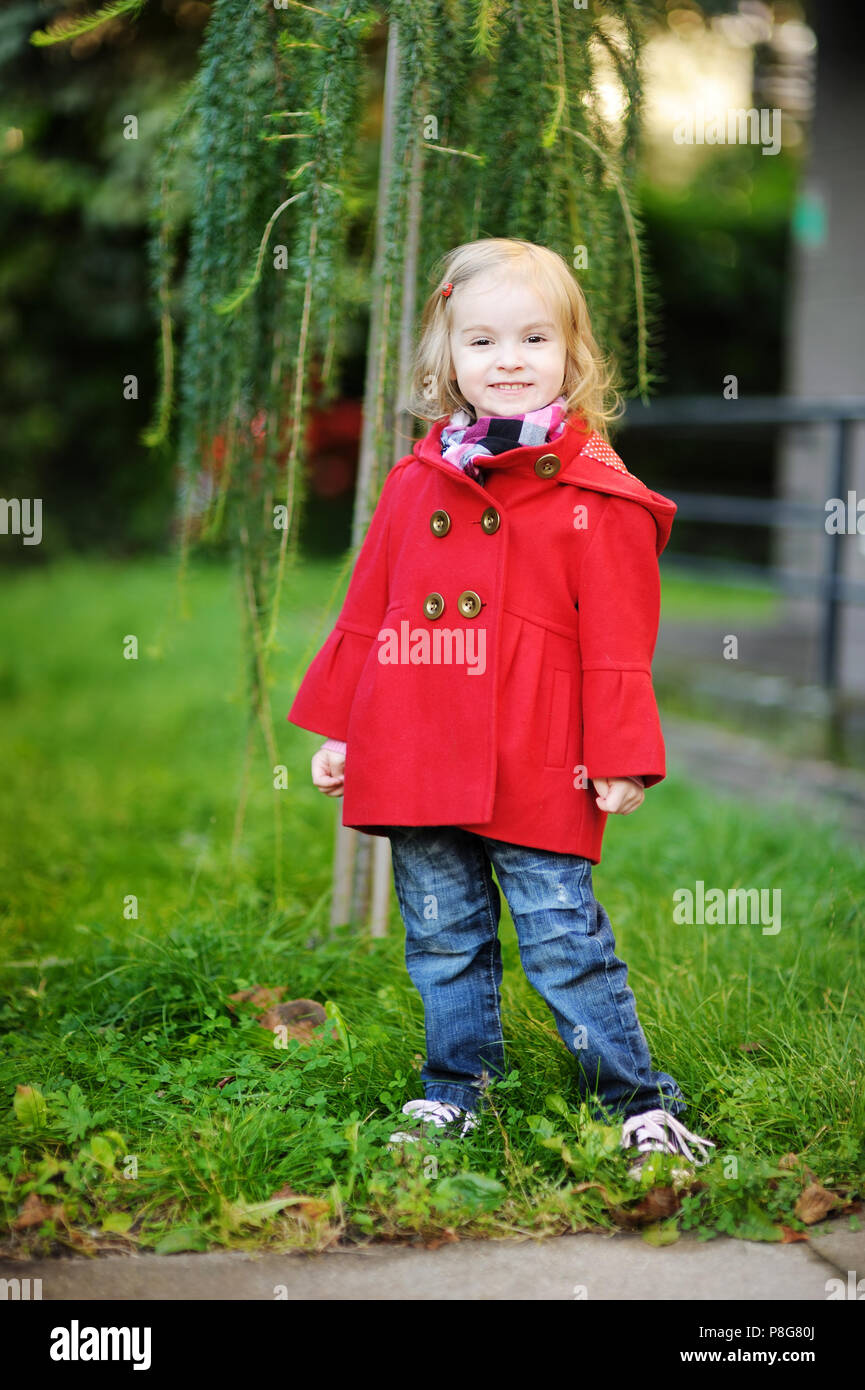 Little girl in a red coat at autumn Stock Photo - Alamy