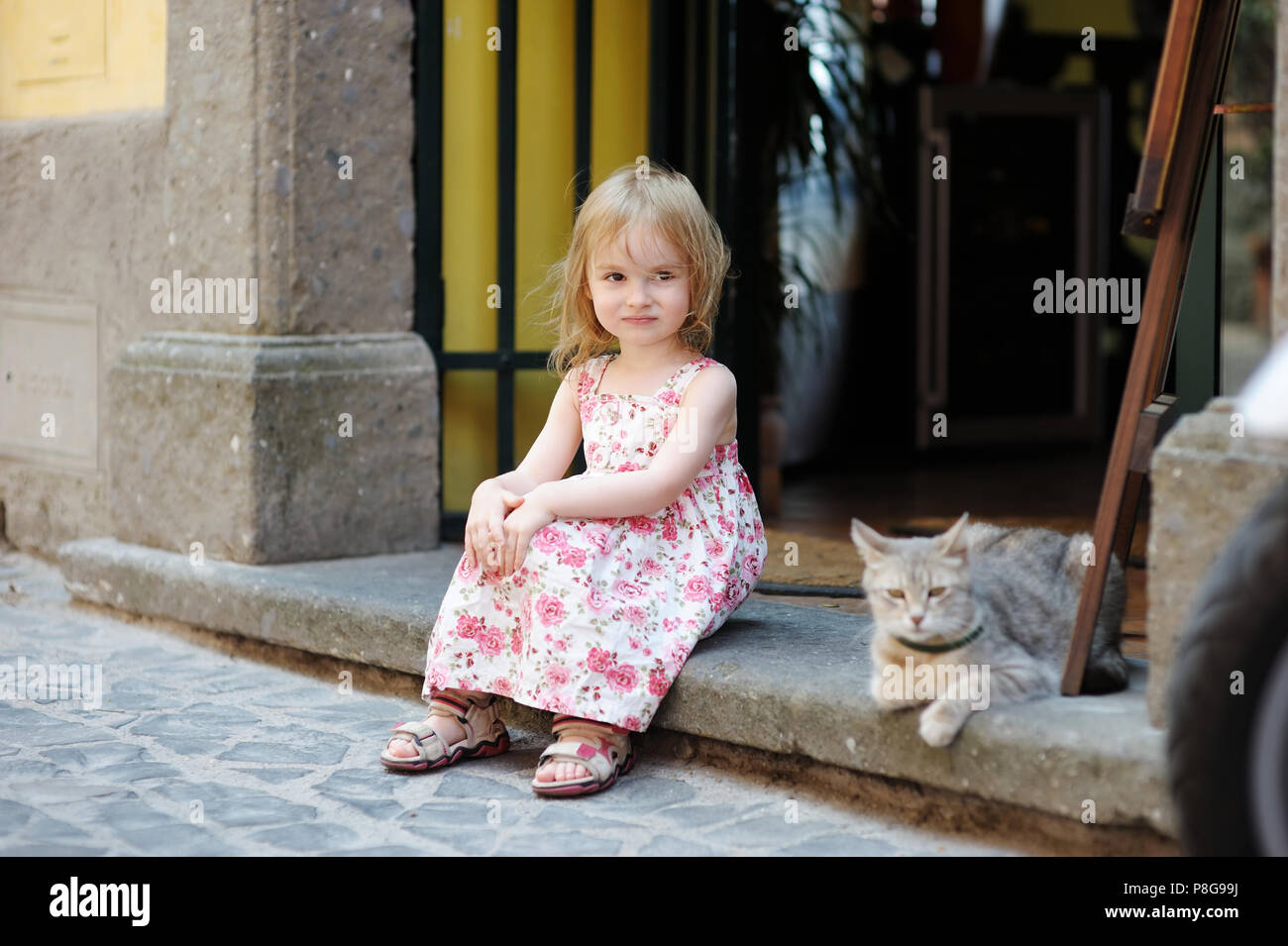 Adorable happy little girl and a cat outdoors Stock Photo - Alamy
