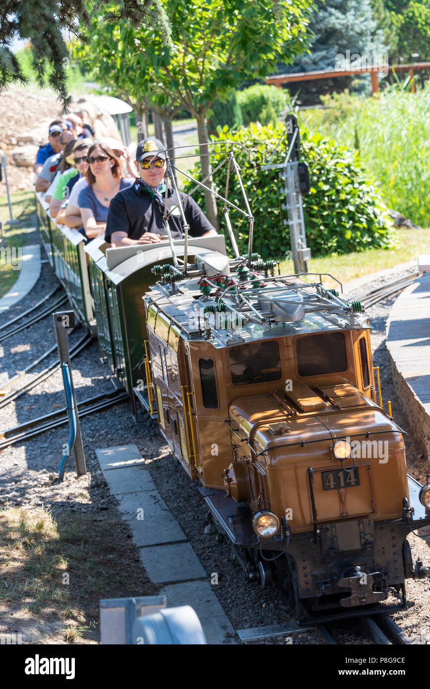 A Miniature Electric Railway Engine Pulling a Passenger Train at the ...