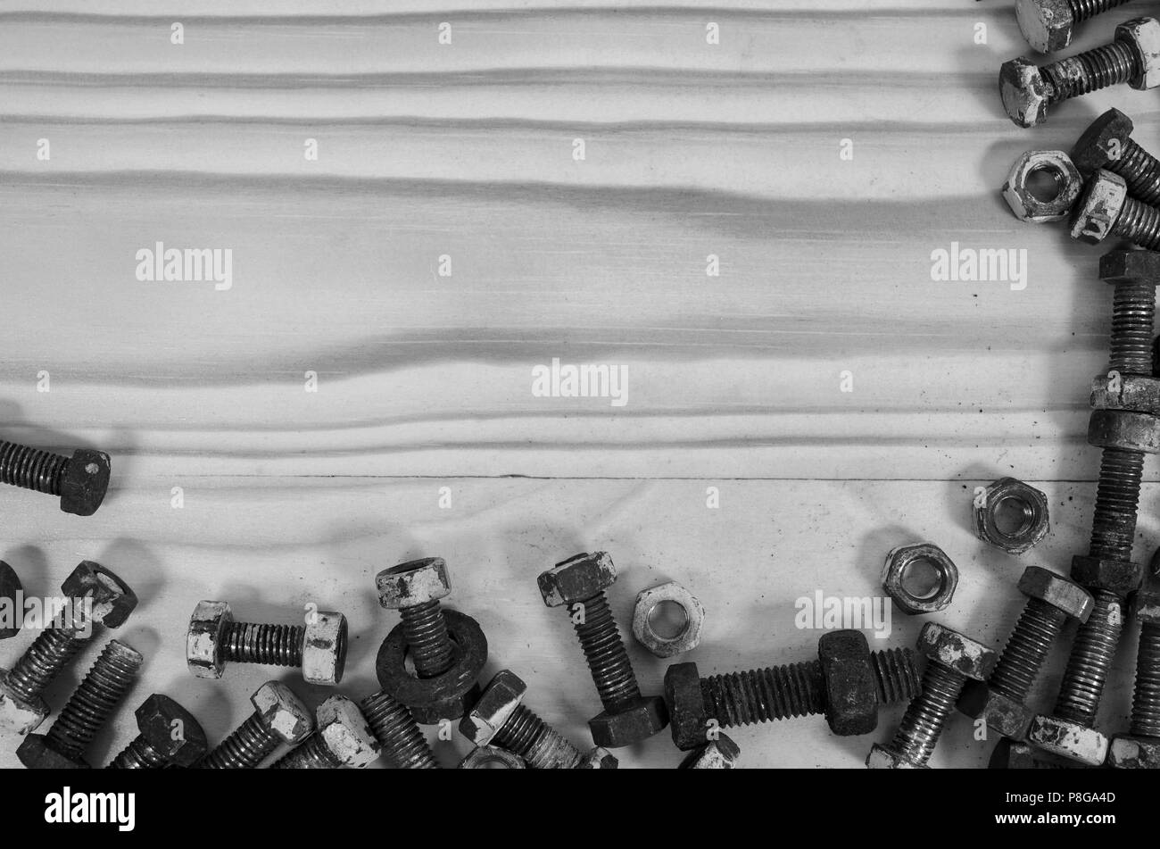 Old bolts and nuts on a wooden table in black and white Stock Photo Alamy