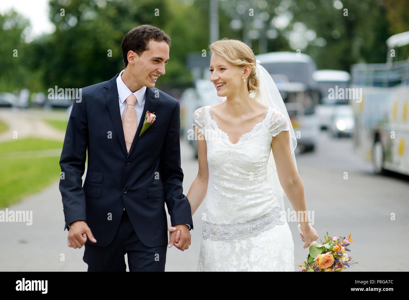 Happy bride and groom walking together Stock Photo - Alamy
