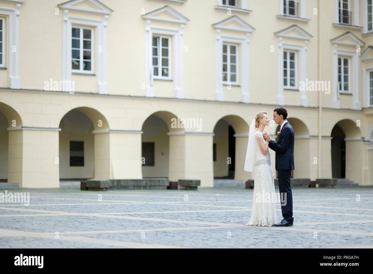 Bride and groom taking a walk in a city Stock Photo - Alamy
