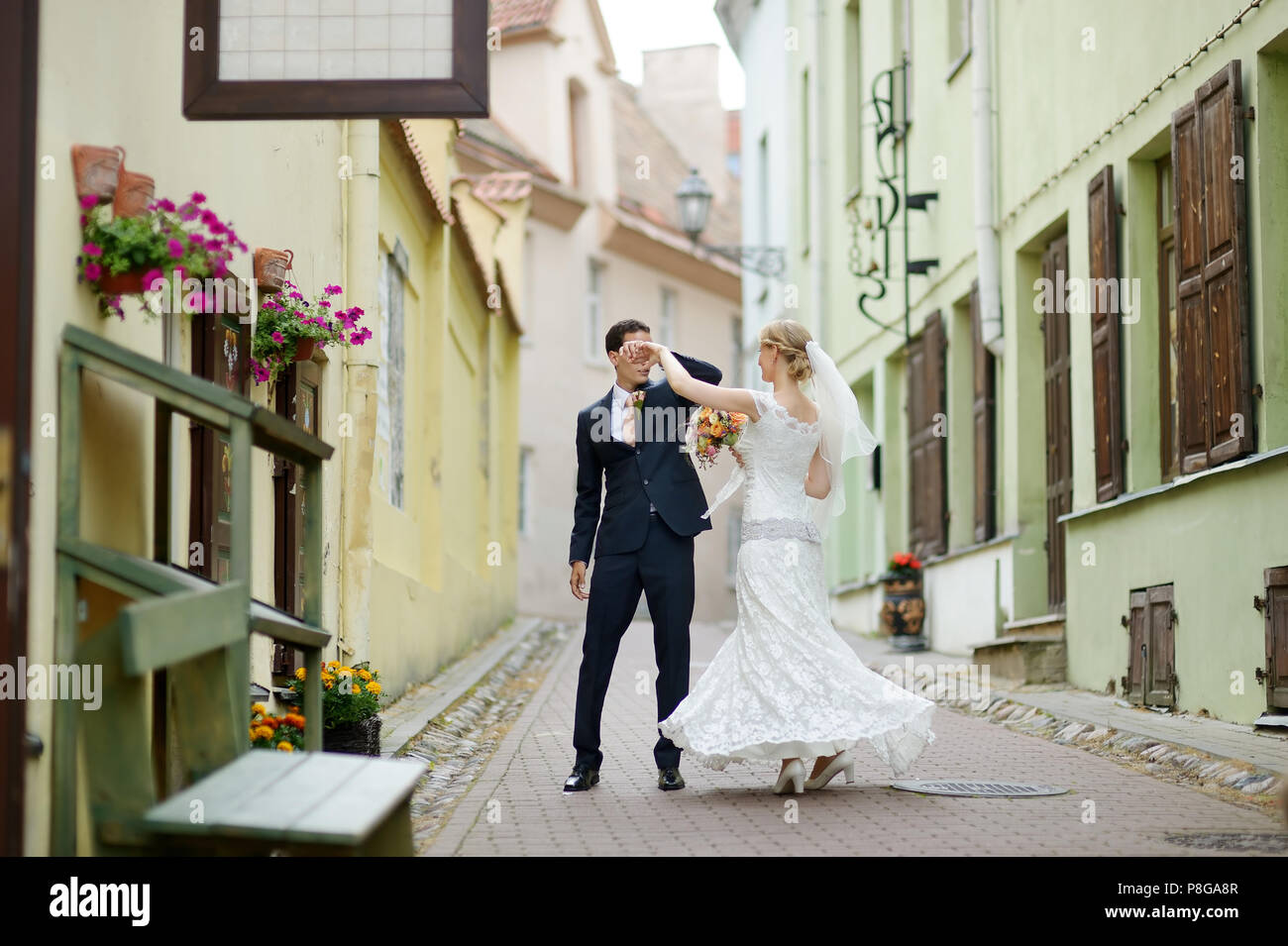 Happy bride and groom dancing on a street Stock Photo - Alamy